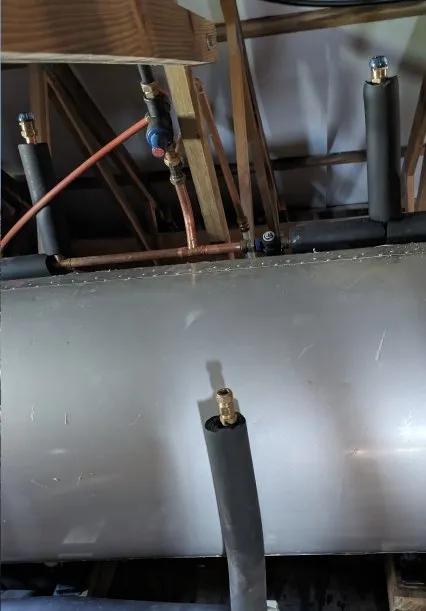 Exposed plumbing run at a construction site.
