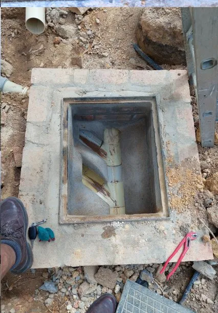 Brickwork drain access cover with internal pipework.